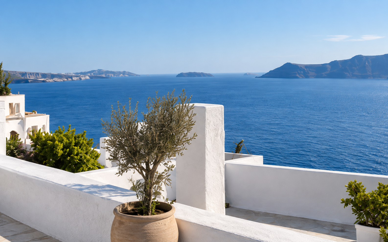 Whitewashed Greek terrace overlooking the Aegean Sea